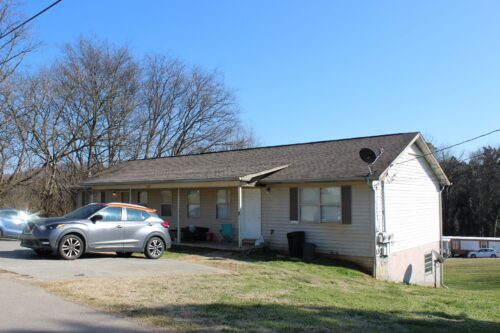 Outdoor shot of trailer home with car