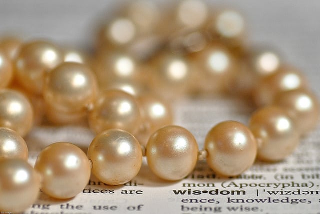 pearls on a newspaper with the word wisdom highlighted